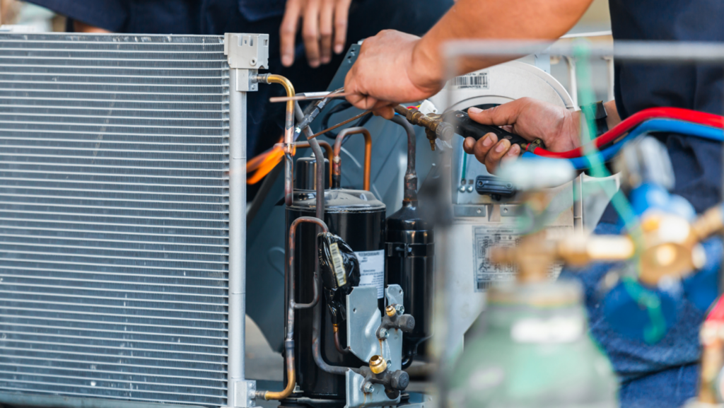 A person utilizes special tools to adjust the internal components of an AC unit.