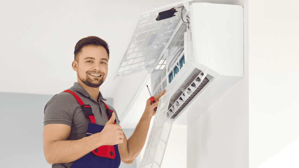 An HVAC technician smiles and gives a thumbs up.